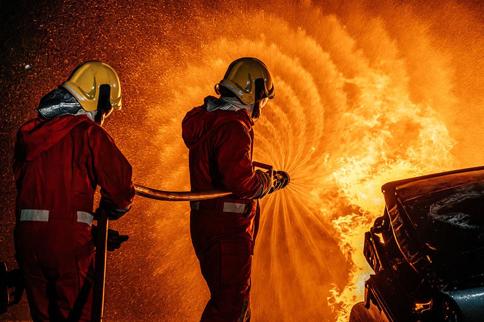 Two fire fighters putting down a fire