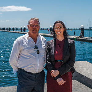 Maurice Blackburn lawyer Caitlin with client Mark standing at the seaside